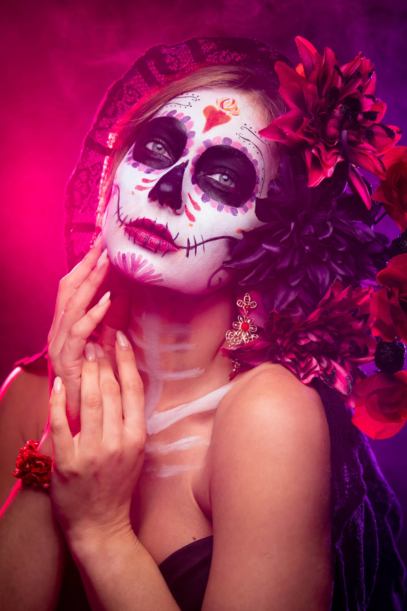 Olesia Prodan in magenta-lit sugar-skull makeup and floral styling