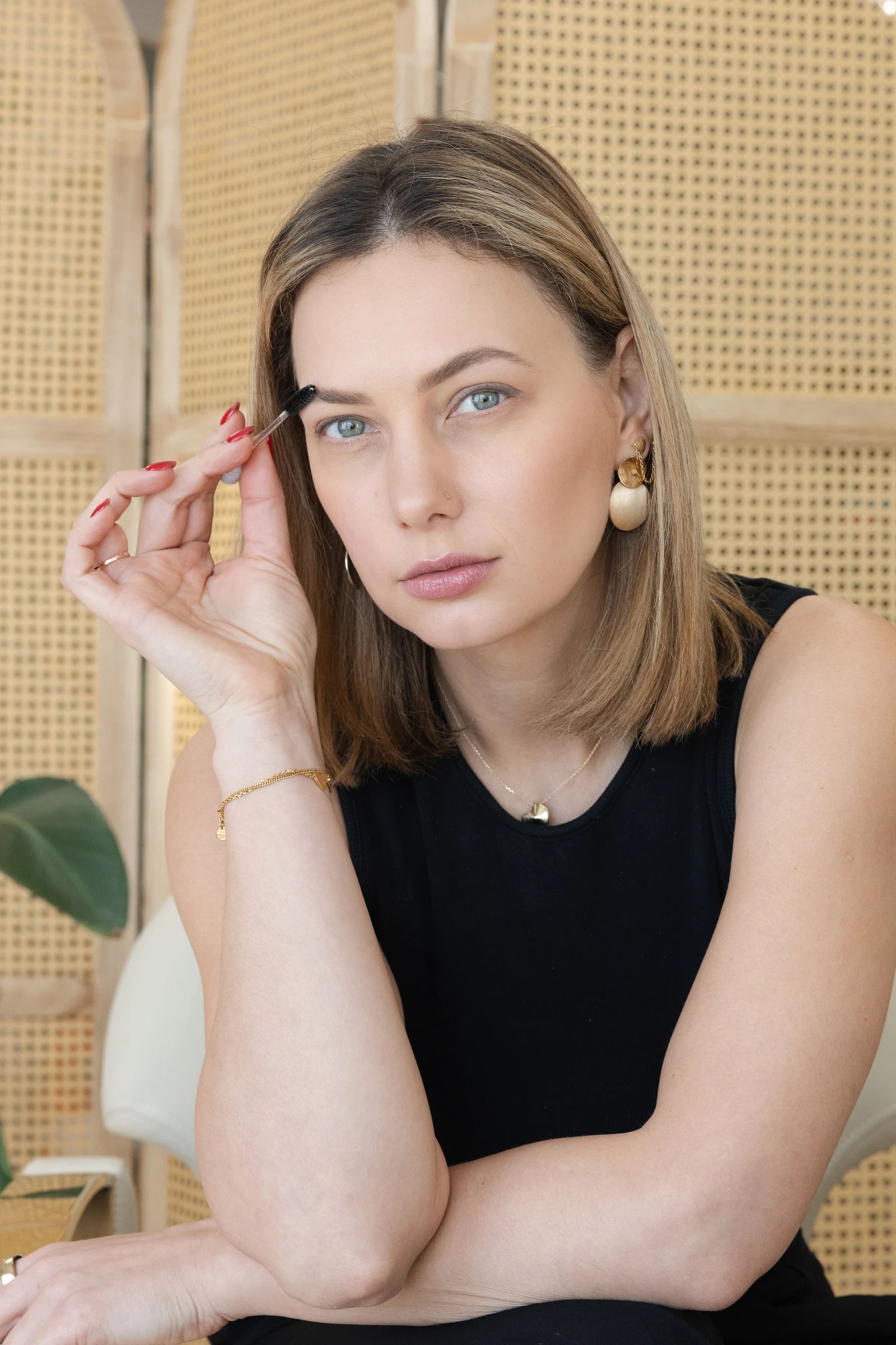 Natural-light beauty portrait of Olesia Prodan in a minimal black look