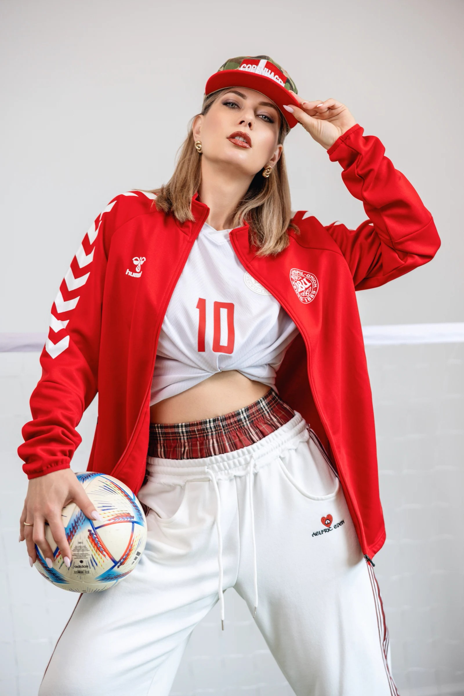 Olesia Prodan in a red-and-white football-inspired commercial look