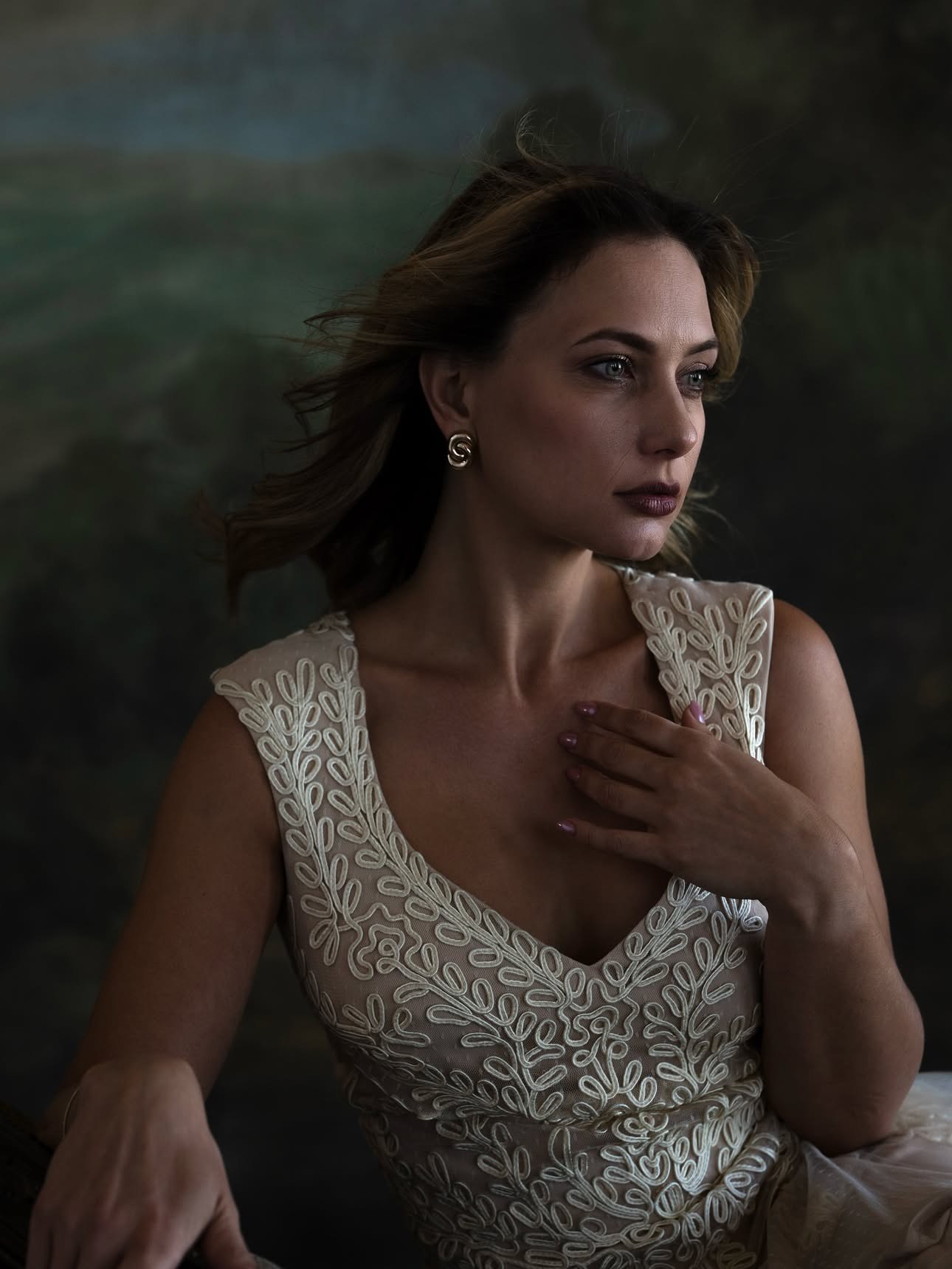 Moody painterly portrait of Olesia Prodan in a white embroidered dress