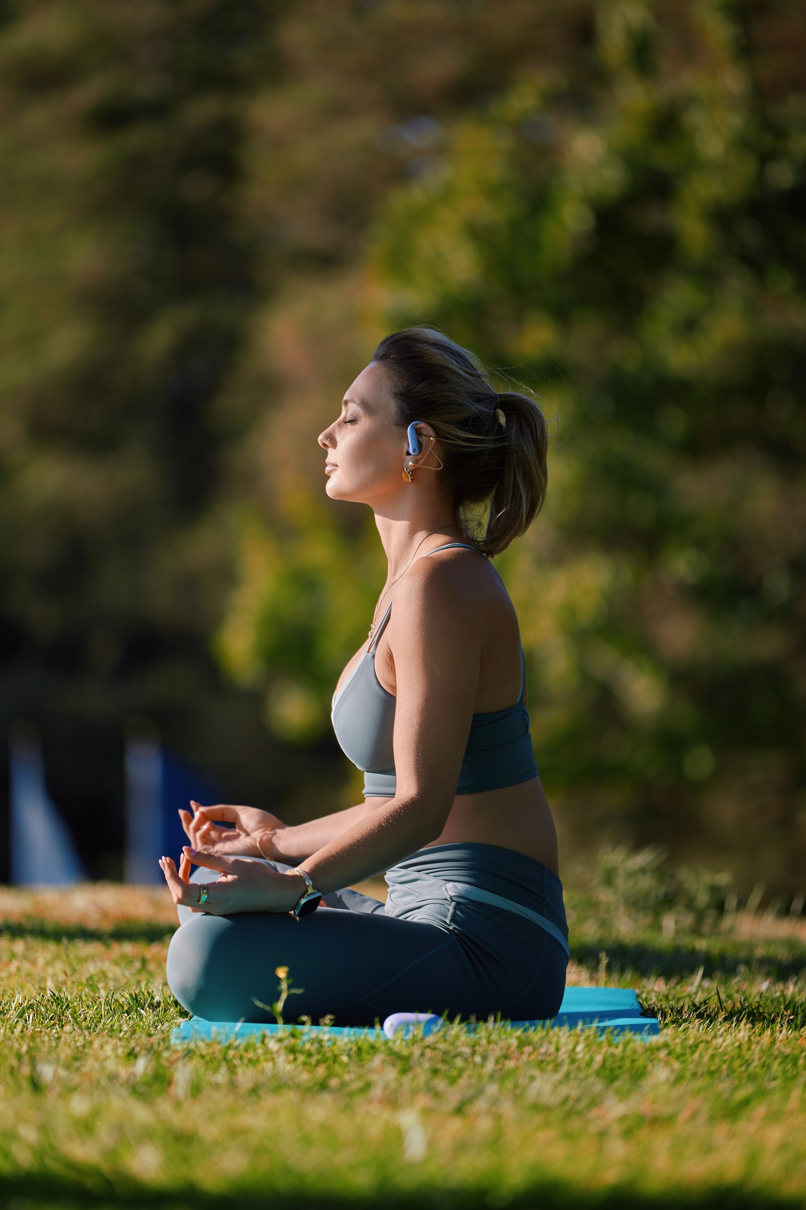 Olesia Prodan practicing yoga outdoors in activewear